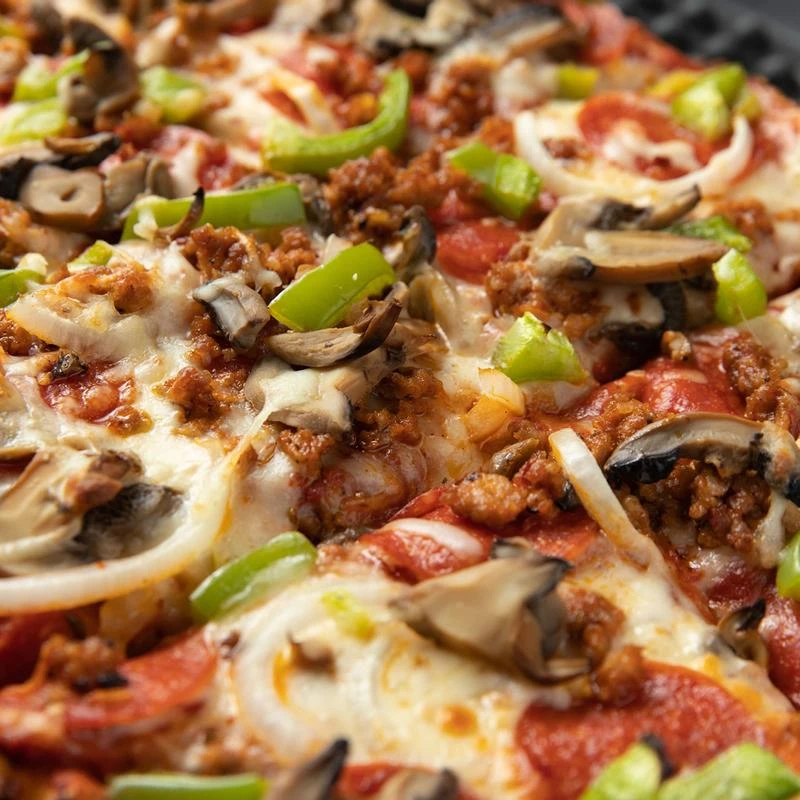 Pizza with sausage, peppers, onions, mushrooms and cheese, closeup