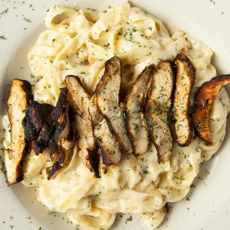 Seasoned blackened chicken with pasta, top view