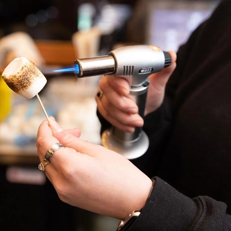 Marshmallow being burnt for a cocktail decoration